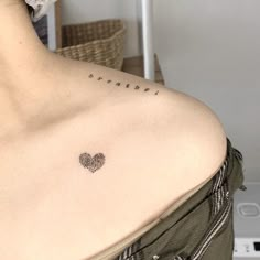 a woman with a heart tattoo on her chest