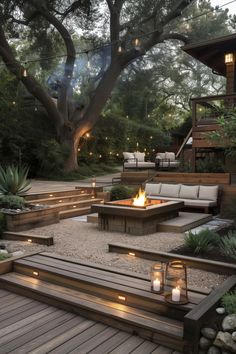 an outdoor fire pit surrounded by wooden steps and benches with lit candles in the middle