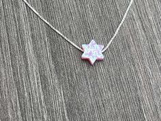 This beautiful Star of David /Magen David/Jewish Star Opal Necklace is sure to be someone's favorite. It's a great Bat Mitzvah or Hanukkah gift. Sterling Silver or 14kt Gold Filled Charm Size: 10mm Lab Created Opal Your Choice of Length and Color Chain Styles: 0.7mm Box Chain Disclaimer: Before placing an order for a necklace or bracelet, please ensure you measure your desired size carefully. Customers are fully responsible for choosing the correct length, as all cut chains are non-refundable. I Spiritual Jewelry For Hanukkah Gift, Hanukkah Gift Pendant Jewelry, Star Of David Charm Jewelry Gift, Sterling Silver Jewelry For Hanukkah Gifts, Star Of David Necklace For Hanukkah Gift, Hanukkah Gift Necklace With Star Of David, White Star Of David Jewelry Gift, Star Of David Necklace For Gift, Judaica Jewelry