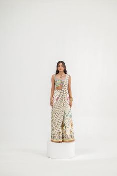 This elegant set features cream kali pants with an attached palla, paired with a hand-embroidered bralette. Combining intricate craftsmanship with a modern silhouette, this outfit is perfect for festive occasions or special events. Traditional Drape Summer Festive Pants, Summer Festive Pants With Traditional Drape, Festive Summer Pants With Traditional Drape, Sleeveless Pre-draped Saree With Intricate Embroidery, Summer Festive Pant Set With Traditional Drape, White Summer Sets For Reception, White Sets For Summer Reception, Summer White Reception Sets, White Summer Reception Sets