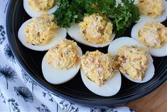 an image of deviled eggs on a plate with parsley sprig in the middle