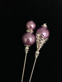 Beautiful handmade hat pins in a lovely shade of pinky violet.   These pins are made with glass faux pearls and silver plated beads and pins.  The pins have an overall length of 15cm/6inches and decorative heads between 3cm and 3.5cm. The 3 designs are:  - Style 1:  double pearl with rhinestones - Style 2: pearl and silver filigree Other pins in similar shades are listed separately and are shown in one of the attached photos. This price shown is for one pin.  You choose the design. All pins come Antique Purple Brooches As Gift, Elegant Purple Rhinestone Brooches, Purple Amethyst Brooch, Luxury Vintage Purple Brooches, Antique Purple Hallmarked Brooches, Purple Pearl, Handmade Hat, Hat Pins, Silver Filigree