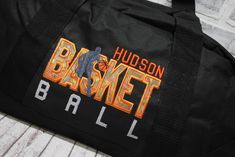 WHY THIS ONE IS SPECIAL: With a orange BASKETball design, this bag is ready to hold all your stuff whether for after school practice, competitions or even a weekend at grandma's! Add a name for a super personalized bag. The HMTO Guarantee: Hand Made To Order means this product is not premade, so this item will be unique and hand crafted just for you! Current Production Times. THREE GREAT STYLES: TOTE bag measures 12x18"with a zippered top. SMALL barrel duffle bag measures 18”x10”x10”, with a side zippered pocket. LARGE square bottom duffle bag measures 24”x12 x11”, with a front zippered pocket. WHY YOU NEED IT: With a design you won’t find anywhere else, these duffle bags show off your favorite activity, while keeping all your gear handy and protected. Both sizes are roomy and fit shoes, c Black School Spirit Bag For College, Customizable Sporty School Bags, Sporty Customizable School Bags, Customizable School Spirit Bag For Everyday, Customizable School Spirit Bags For Everyday Use, Orange Basketball, Basketball Bag, Favorite Activity, Personalized Basketball