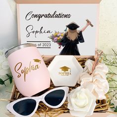 the graduation gift box is filled with personalized items, such as sunglasses and a coffee mug