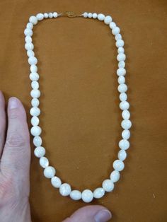 (Internal #V461-30)  You are bidding on a beautiful, handmade mother of pearl white beaded necklace with 8x10mm oval and 10mm round beads, 20” long with gold alloy safety clasp closure.  LOVELY.This is the exact necklace you will receive.WE SHIP WORLDWIDE! Other accepted payment: Credit card (Mastercard/Visa/Discover) inquire for details. Single Strand Pearl Jewelry With Oval Beads, Pearl White Oval Beads Jewelry Gift, Round Pearl Necklace With Large Beads For Jewelry Making, Pearl White Oval Beads Jewelry For Gift, Beaded Mother Of Pearl Jewelry With Round Beads, Mother Of Pearl Beaded Jewelry With Round Beads, Single Strand Mother Of Pearl Necklace With Round Beads, Large Beads Pearl Necklace As Gift, Vintage White Gemstone Beads Jewelry