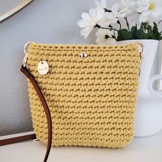 This gorgeous crocheted crossbody bag in vibrant Honey is petite yet roomy.  It's just the right size to hold your everyday essentials for a fuss-free day out.   Lovingly crocheted by hand, this bag is one of a kind. Whether you're stepping out for a casual outing or headed to a chic brunch, this small crossbody bag is ready to compliment any outfit with charm.  This bag is extremely durable and eco-friendly, crocheted with 100% recycled cotton cord.  The brown leather strap is adjustable and th Yellow Crossbody Bag Gift, Yellow Mobile Phone Bag As Gift, Yellow Shoulder Bag With Adjustable Strap As Gift, Handmade Crochet Crossbody Bag For Everyday, Crochet Mobile Phone Pouch Bag As Gift, Everyday Handmade Crossbody Crochet Bag, Yellow Bag With Adjustable Strap As Gift, Yellow Shoulder Bag With Removable Pouch As Gift, Yellow Bags With Adjustable Strap As Gift