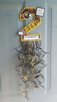 a bunch of wire hanging from the side of a door with a sign on it