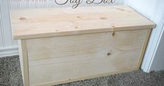 a wooden toy box sitting on the floor in front of a wall with words how to build a toy box