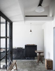 an empty room with two benches and a table