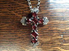 A stunning antique sterling silver cross pendant set with faceted garnets and decorated with marcasites on a long sterling silver belcher chain. The seven prong set dark red faceted garnets are square and round cut. The pendant is marked 925 for sterling silver and has a Birmingham maker's mark. It probably dates from the early 1900s. The 55 cm belcher chain is 2.5 mm wide with a spring ring fastening. This item is in good condition with one damaged marcasite shown in the last photo. Thank you f Vintage Red Cross Jewelry, Victorian Crucifix Jewelry For Gifts, Antique Silver Garnet Jewelry, Antique Silver Cross Necklace Gift, Antique Silver Cross Necklace As Gift, Antique Silver Cross Necklace For Gift, Gothic Silver Garnet Jewelry, Elegant Red Cross Pendant Jewelry, Belcher Chain