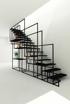 a black and white staircase with bookshelf next to it in an empty room