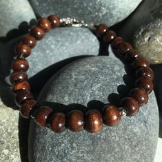 Unique mocha wood prayer beads bracelet with pewter accents. Custom length available ensuring a perfect fit.  Please specify your size in the comments of your order along with elastic or toggle closure. IF NO SIZE IS SELECTED, DEFAULT WILL BE ELASTIC AND MEDIUM (7.5 inches Petite (6.5) Inches Small (7.0) Inches Medium (7.5) Inches Large (8.0) Inches Custom (pls specify) Inches We are willing to work with you on a custom design as well so you have that original one of a kind piece! All of our items are shipped in a velvet pouch so you can safely store your piece for years to come! With local pickup or FREE US shipping, you can have this in no time!  For international shipping, please see other listing. Cheap Brown Spiritual Beaded Bracelets, Spiritual Brown Bracelets With Wooden Beads, Brown Wooden Beaded Bracelets With 8mm Beads, Brown Spiritual Bracelet With Spacer Beads, Spiritual Brown Beaded Bracelets With Wooden Beads, Spiritual Brown Bracelet With Spacer Beads, Meditation Brown Bracelet With Polished Beads, Spiritual Brown Wooden Beaded Bracelets, Brown Wooden Bracelets With Round Beads