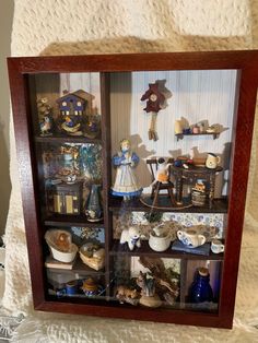 a display case filled with lots of figurines and knick - knacks