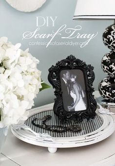 a black and white photo frame sitting on top of a table next to vases