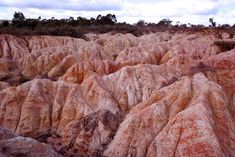 the landscape is very colorful and has many rocks on each side, with trees in the distance