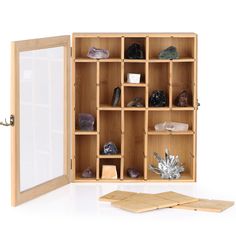 an open wooden cabinet with rocks and crystals