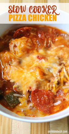 a bowl of slow cooker pizza chicken soup on a wooden table with text overlay