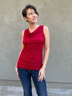 women's plant based rayon jersey red top with ruching on sides and slight cowl neck #color_red Ruched Top With Stretch And Asymmetrical Neckline, Stretch Top With Ruched Asymmetrical Neckline, Asymmetrical Neckline Stretch Tops, Asymmetrical Neckline Top With Ruched Stretch, Asymmetrical Neckline Top With Ruched Detail, Stretch Draped Tops, Ruched Draped Top In Elastane, Versatile Top With Asymmetrical Neckline, Ruched Draped Elastane Top