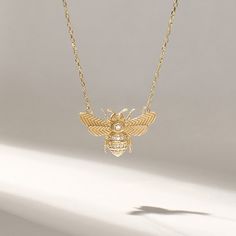 Embrace the beauty of nature and add a touch of whimsical elegance to your daily attire with our Pave Diamond Realistic Bee Necklace. Crafted in genuine 14k solid yellow gold, this necklace showcases the intricate and lifelike details of a 3D honey bee. The bee pendant sparkles with pave diamonds, creating a stunning contrast to the rich gold, making it a statement piece that catches the eye. Whether you wear it as a daily necklace or for special occasions, it adds a touch of sophistication and charm to your style, making it a perfect gift for nature enthusiasts, bee lovers, or anyone who appreciates unique and symbolic jewelry. Features * Made to Order. * Gold KT: 14KT * Custom Gold Color: Yellow Gold * Charm 12.80mm x 20.10mm * Charm Thickness: 1.25 mm * Diamond Color-Clarity: D-E-F colo Gold Bee Necklace, Daily Necklace, Bee Pendant, Gold Bee, Symbolic Jewelry, Bee Necklace, Arm Candy, Gold Charm, Honey Bee