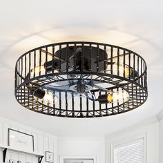 a ceiling light that is hanging from the ceiling in a room with white walls and cabinets