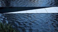 a stop sign sitting on the side of a body of water