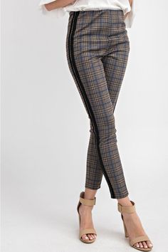 The Plaid Me Up ponte skinny pants/leggings are a classic with a twist that are so easy to wear with a stretchy waistband. The black racer stripe up the side of the leg adds a fun twist to a classic plaid. We love this styled with our Sophie turtleneck tunic or the Mia cowl neck. Offered in Olive 97% polyester, 3% spandex Imported Model is 5'8" and wearing a small Recommend to size up for a not so skinny fit Olive color option has the blue stripe detail Ash gray color option has the pink stripe Plaid Pants Outfit, 60’s Fashion, Plaid Pants Women, Winter Pants Outfit, Rhinestone Jeans, Turtleneck Tunic, Black Racer, Ponte Leggings, Ash Gray