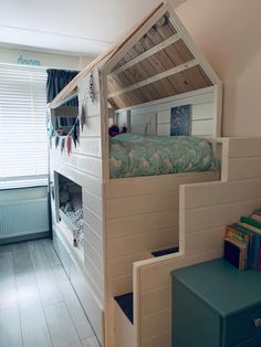 a bunk bed is built into the side of a wall in a child's room