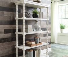 a white book shelf sitting on top of a wooden floor