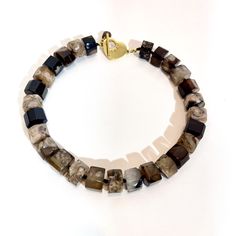 A combination of natural brown and cream colors in each stone.  A wheel shape beads to display the beauty of the agate stone.   Agates are clusters of tiny quartz that share similar components, like hardness and color. This necklace measures 18 inches long and weighs 9 ounces. The color is rich and easy to wear. Resin And Clay, Agate Necklace, I Design, Natural Brown, Agate Stone, Semiprecious Stones, Rich Color, Cream Color, Agate