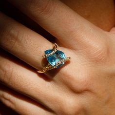 https://youtu.be/IafBcWaYOTcMystic Eden Ring. Mystic Eden Ring. Blue Topaz: "The Communicator" Description: With its mesmerizing light blue color, this breathtaking cocktail ring radiates glam and royalty. Materials Description:- 14k gold.- Mesmerizing pear-shaped bright blue Topaz.- 0.22 ct diamonds.- Rough texture, high polish. Blue Topaz's qualities:There is an assumption that with its soothing blue shade, this magnificent gemstone can help promote our perspective and concentration by channel Blue Trillion Cut Ring With Diamond Accents, Blue Trillion Cut Diamond Jewelry, Fine Jewelry Trillion Cut Topaz Ring, Fine Jewelry Topaz Ring With Trillion Cut Gemstone, Fine Jewelry Topaz Ring With Trillion Cut, Fine Jewelry Crystal Topaz Ring With Accent Stones, Trillion Cut Blue Topaz Promise Ring, Trillion Cut Blue Topaz Ring With Accent Stones, Trillion Cut Topaz Ring With Accent Stones