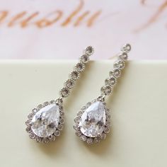 Tiny Vintage Style Bridal Earrings, Art Deco Earrings, Wedding Earrings Tiny  vintage style zircon  earrings  Colour: rhodium(silver tone) /clear Measurements: approx 3.6 cm x 1cm .  Materials:  rhodium components, zircon crystals . Stud earrings. Great for wedding or other celebration. MORE SAME STYLE: https://www.etsy.com/uk/shop/BridalArtDeco?ref=listing-shop-header-item-count&section_id=23918122 Please note some images have been enlarged to allow for details to be shown. Read the descriptions for details on actual size of each item.In all my shop listing I have made every effort to ensure that the images match the item as closely as possible! However, colours do vary on different monitors.  Thank you for visiting / shopping ! Wedding Halo Drop Diamond Earrings, Wedding Drop Diamond Earrings With Halo Design, Wedding Halo Design Drop Diamond Earrings, Bridal Drop Earrings With Halo Design, Halo Design Bridal Drop Earrings, Elegant Drop Diamond Earrings For Wedding, White Teardrop Earrings With Prong Setting For Wedding, Elegant Pear-shaped Diamond Earrings For Wedding, Cubic Zirconia Bridal Earrings With Halo Design For Wedding