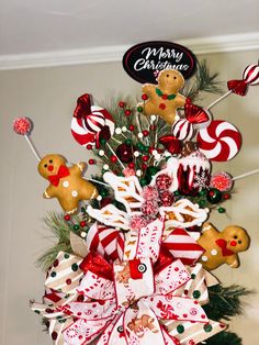 a christmas tree decorated with candy canes and gingerbreads for the holiday season