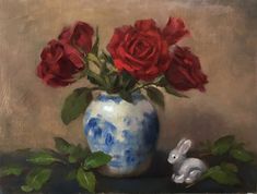 a painting of red roses in a blue and white vase with a bunny figurine