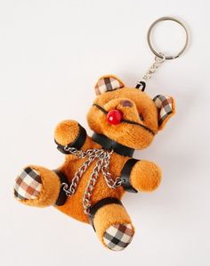 Show off your hardcore side with this Gagged Teddy Bear Keychain. You'll love showing off your love for bondage by accessorizing any bag or set of keys with this kinky keychain. Dimensions: 4" H x 4" W Material: Silicone, polyurethane leather, plastic, metal Care: Spot clean Imported Leather Teddy Bear, Titanium Belly Ring, Teddy Bear Keychain, Labret Jewelry, Cartilage Ring, Bear Keychain, Nose Bones, Eyebrow Ring, Piercing Aftercare