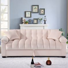 a pink couch sitting on top of a white rug