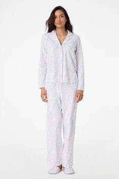 Stay cozy in bed in these new soft and plush PJs that feature our chic hearts print in a vibrant multi-rainbow colorway. This pajama set includes a long-sleeve polo top and matching bottoms. 4 Buttons Chest Pocket Elastic Waistband Materials and Care 100% Long-Staple Premium Cotton Machine wash warm with like colors. Do not bleach Line Dry recommended. Warm iron if needed Imported Measurement Information Model Wears Size Small Model Height: 5' 10.5" Size S Length: 25" (from Shoulder) Size S Slee Multicolor Long Sleeve Sleepwear For Lounging, Multicolor Relaxed Fit Sleepwear For Pajama Party, Multicolor Long Sleeve Loungewear Sleepwear, Multicolor Long Sleeve Sleepwear For Loungewear, Multicolor Relaxed Fit Sleepwear For Bedtime, Multicolor Long Sleeve Relaxed Fit Sleepwear, Multicolor Relaxed Fit Long Sleeve Sleepwear, Cozy In Bed, Hearts Print