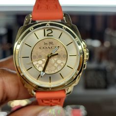 Women's Orange Silicone Strap Coach Boyfriend Watch. This Watch Has A Gold Face With Signature Coach "C" Imprinted In Dial. Orange Analog Watch With Round Dial, Boyfriend Watch, Gold Face, Coach Accessories, Gold Orange, Orange Gold, Michael Kors Watch, Accessories Watches, Michael Kors