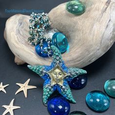 Handpainted shimmery pewter Starfish Fairy Pendant hung on a green mystic pyrite rosary chain, Ocean colors, unique one-of-a-kind piece. Dive into the enchanting world of fairies with our Hand-painted Magical Ocean Starfish Fairy Pendant Necklace. This unique one-of-a-kind piece made of lead and nickel-free pewter features a beautifully crafted starfish fairy pendant, meticulously hand-painted to capture the ocean's mystic charm and vibrant colors. The pendant is set on an 18-inch silver-plated chain adorned with mystic pyrite beads, adding a touch of sparkle and magic to your look. The necklace includes a 2-inch extender, allowing for versatile wear and perfect fit. Whether you're dressing up for a special occasion or adding a bit of whimsy to your everyday attire, this necklace is sure t Handmade Green Starfish-shaped Jewelry, Handmade Green Starfish Jewelry, Handmade Green Star-shaped Jewelry, Green Star-shaped Handmade Jewelry, Magical Ocean, Ocean Starfish, Fairy Pendant, Pewter Pendant, Ocean Colors