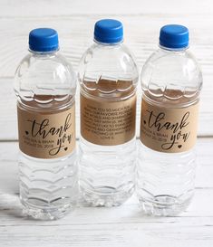 three water bottles with thank you labels on them