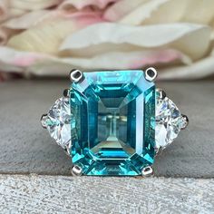 Paraiba Tourmaline Engagement Ring White Gold Emerald Cut Neon Blue Paraiba Tourmaline Ring For Women Unique Ring Moissanite Trillions #6824 #ParaibaTourmaline #EngagementRing #EmeraldCut #Paraiba #Wedding #WhiteGold #Unique #NeonBlue #TourmalineRing #RingForWomen Blue Tourmaline Engagement Ring, Blue Tourmaline Ring, Paraiba Tourmaline Engagement Ring, Paraiba Tourmaline Ring, Tourmaline Engagement Ring, Charles And Colvard Moissanite, Paraiba Tourmaline, Engagement Ring White Gold, White Gold Set