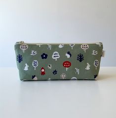 Cute cartoon nature fabric large capacity pencil case, pencil pouch, zipper bag, cosmetic bag, makeup bag Handmade in the UK Size:  - approximately 23cm (L) x 9cm (H) with 5cm base Material:  - 100% cotton (both outer and inner layer) - YKK zipper closure Notes:  - The position of pattern prints may slightly vary due to the different batches of the fabric - The actual color may slightly vary due to lighting effects and monitor settings Green Pouch Pencil Case For Daily Use, Green Pencil Case Pouch For Daily Use, Green Pouch Pencil Case With Zipper, Green Pencil Case With Zipper Closure, Green Pencil Shaped Case With Zipper Closure, Cute Green Zipper Pouch Pencil Case, Green Pencil Case With Zipper Closure For Gift, Green Pencil Case With Zipper Closure As Gift, Cute Green Pencil Case With Pen Holders