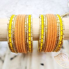 Beautifully designed bangles for any occasion. South asian bracelets come in a variety of styles, colors, and finishes. We at Banglez take creating the perfect bangle set for you to another level! You could say helping you find your favorite stack of bangles as one of our greatest missions. This bangle set was curated in house by one of our talented team members. We hope you love them as much as we do! Adjustable Orange Jewelry For Festivals, Orange Bracelet For Festivals As Gift, Orange Bracelets For Festivals Gift, Orange Bracelets As Festival Gifts, Orange Festival Bracelet As Gift, Bohemian Orange Bangle Jewelry, Orange Bohemian Bangle Jewelry, Adjustable Orange Bracelets For Festivals, Adjustable Yellow Round Bangle