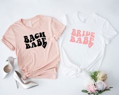 Bride Babe Shirt, Bach Babe, Bride shirt, Team Bride T-Shirt, Bridesmaid shirt, Bachelorette Party Tee, Bridal Party Ideas, Bride Team Shirt Hi Everyone, Welcome to our shop, it is very nice to see you here, If you have any question/concern or want to order customize, please do not hesitate and feel free to contact us. To get the most best size for your order, make sure to check the size chart. Please note that unisex t-shirts are often run big. Unfortunately we do not accept any returns or exch Short Sleeve Summer Wedding Tops, Summer Wedding Tops With Short Sleeves, White Short Sleeve Shirt For Bachelorette Party, Pink Crew Neck Top For Wedding, Spring Wedding Crew Neck Top, White Short Sleeve Top For Bridal Shower, Short Sleeve Graphic Print Shirt For Wedding, Fitted Summer Tops For Bridal Shower, Summer Wedding Cotton Shirt