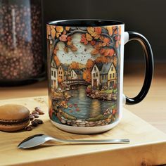 a coffee mug sitting on top of a wooden table next to a spoon and fork