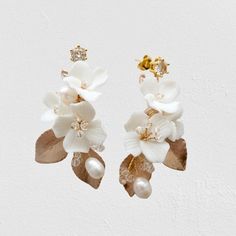 Elegant and romantic, this exquisite pair of earrings is a trendy accessory for your Special Day. Adorned with a combination of delicate ceramic flowers and glowing crystals on a silver/gold base, it will add an extra touch of glam to finish off your perfect look on your perfect day. Length - 2.1" (approx. 5.4cm); Width - 1.2" (approx. 3cm); Weight - 3.6g. Cast in lightweight alloy and silver / gold plated for a flawless finish, the earrings are hypoallergenic - lead, nickel and cadmium free. Av Luxury White Elegant Flower Earrings, Luxury Delicate White Flower Earrings, Gold Nature-inspired Flower Earrings, Glamorous Flower-shaped Wedding Earrings, Luxury Silver Flower-shaped Bridal Earrings, Trendy Accessories, Ceramic Flowers, Look On, Perfect Day