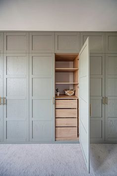 an empty room with white walls and cabinets