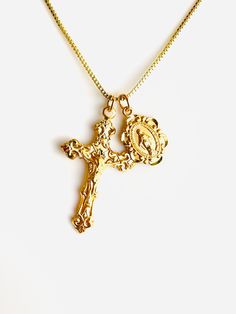 "This is a beautiful gold or silver double charm necklace featuring a 16k gold over 925 sterling silver Italian style crucifix cross pendant alongside a 16k gold over a small 925 sterling silver Mother Mary miraculous medallion.  Both pendants come together on a 1mm 14k gold-filled box chain. This is an incredible piece of heirloom jewelry for women!  These gorgeous charms are made by master silversmiths here in the USA.  Such attention to detail these charms are so exquisite that the photos do not do them justice!  Cross is shiny measures 28x17mm.  Miraculous measures 12x8mm with Mother Mary seal on backside. This necklace comes in a 16\", 18\", 20\" length. Comes in a gift box ready to present. Model has a small necklace, is wearing the 16\" length. This necklace is also available 925 st Madam Secretary Jewelry, Spiritual Crucifix Charm Necklace, Crucifix Charm Necklace As Gift, Yellow Gold Charm Necklaces With Cross Pendant, Crucifix Charm Necklace For Gift, Gold Cross Charm Necklaces, Gold Plated Crucifix Necklace Tarnish Resistant, Figaro Chain Cross Necklace As Gift, Gold Plated Tarnish Resistant Crucifix Necklace