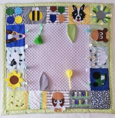 a child's play mat made out of fabric and felt with animals on it