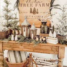 a wooden table topped with lots of christmas decorations next to a sign that says tree farm