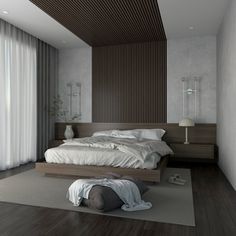 a large bed sitting on top of a wooden floor next to a white curtained window